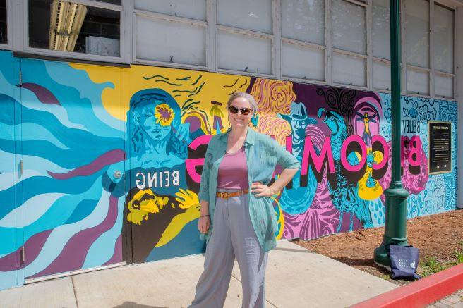 Heather Hogan in front of Becoming Mural