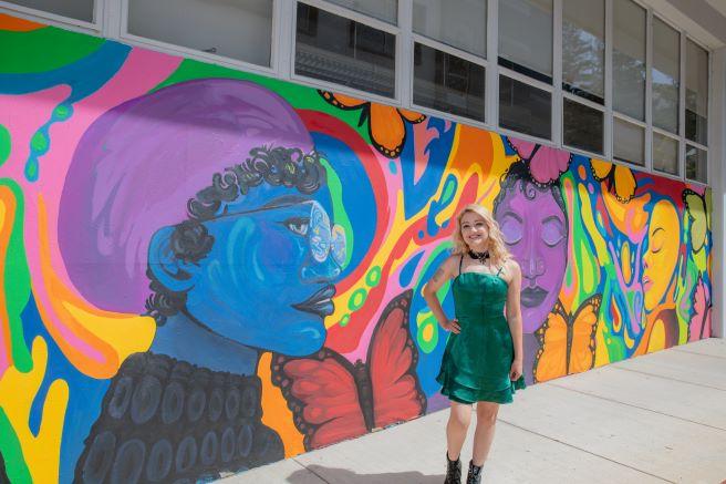 Jaci Zemenchik in front of Becoming Mural