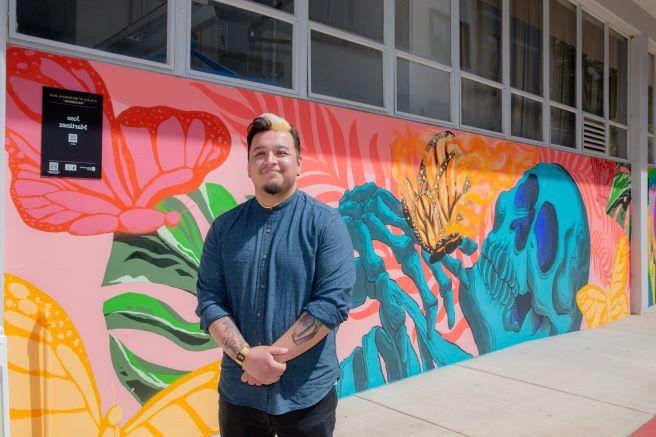 Jose Martinez in front of Becoming Mural